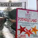 Residents of Welsh village fed up with road potholes turn them into amusement park