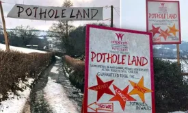 Residents of Welsh village fed up with road potholes turn them into amusement park