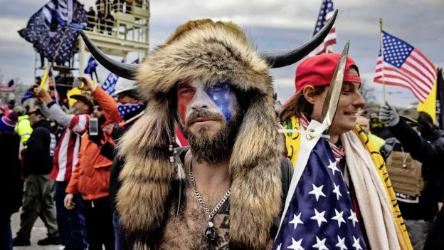 QAnon Shaman Celebrates New Guns After Trump's Pardon: 'I Love This Country'